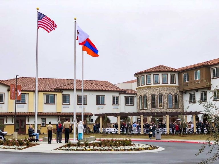 Senior lifestyle community celebrates completion with symbolic flag raising dedication